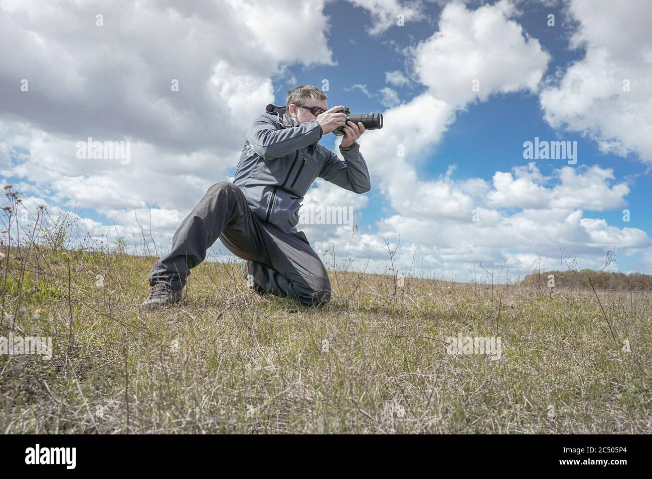 Wild life Nature photographer take a picture in field Stock Photo