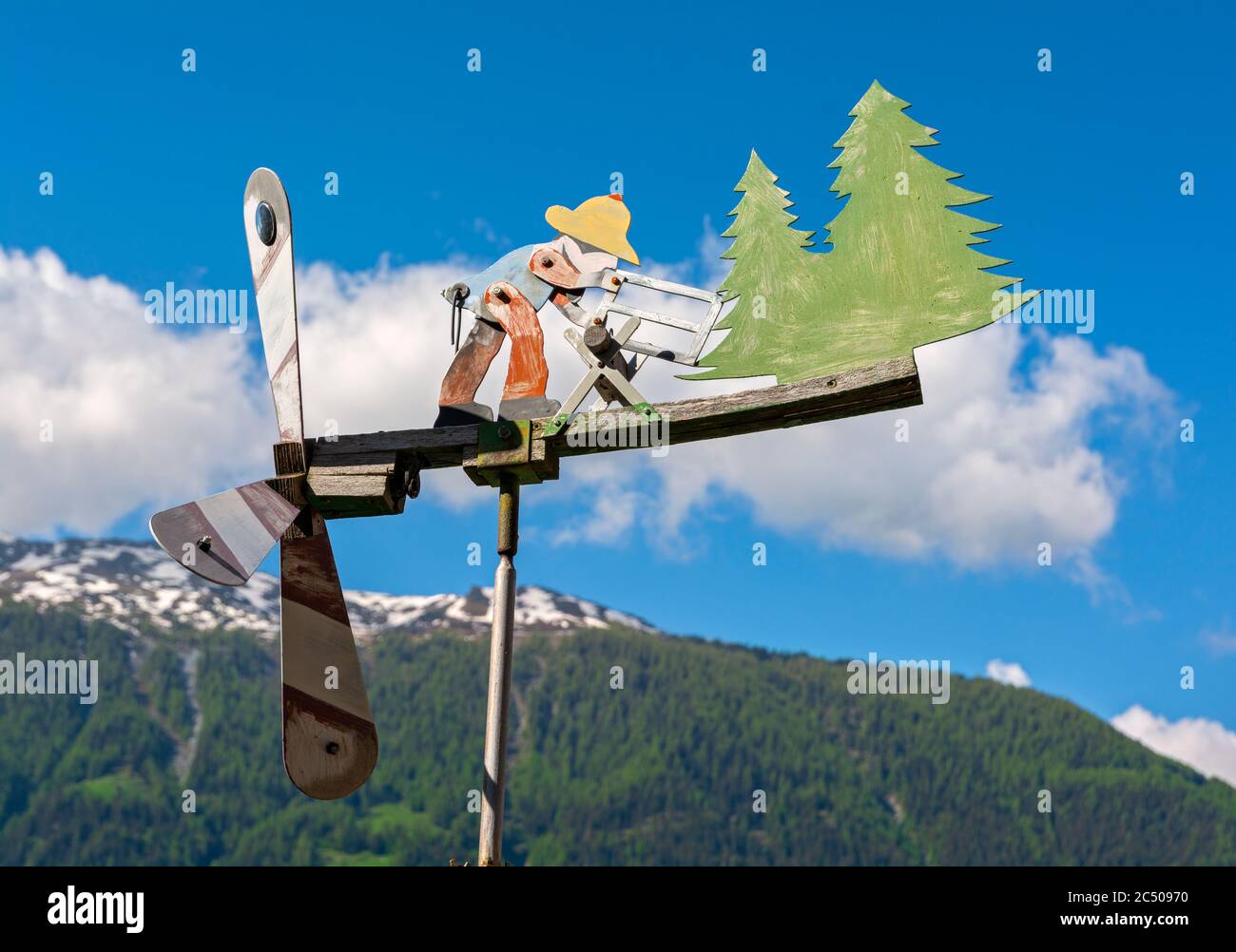Switzerland, Valais Canton, Val d'Herens, Saint Martin, weather vane with wind driven moving figure Stock Photo