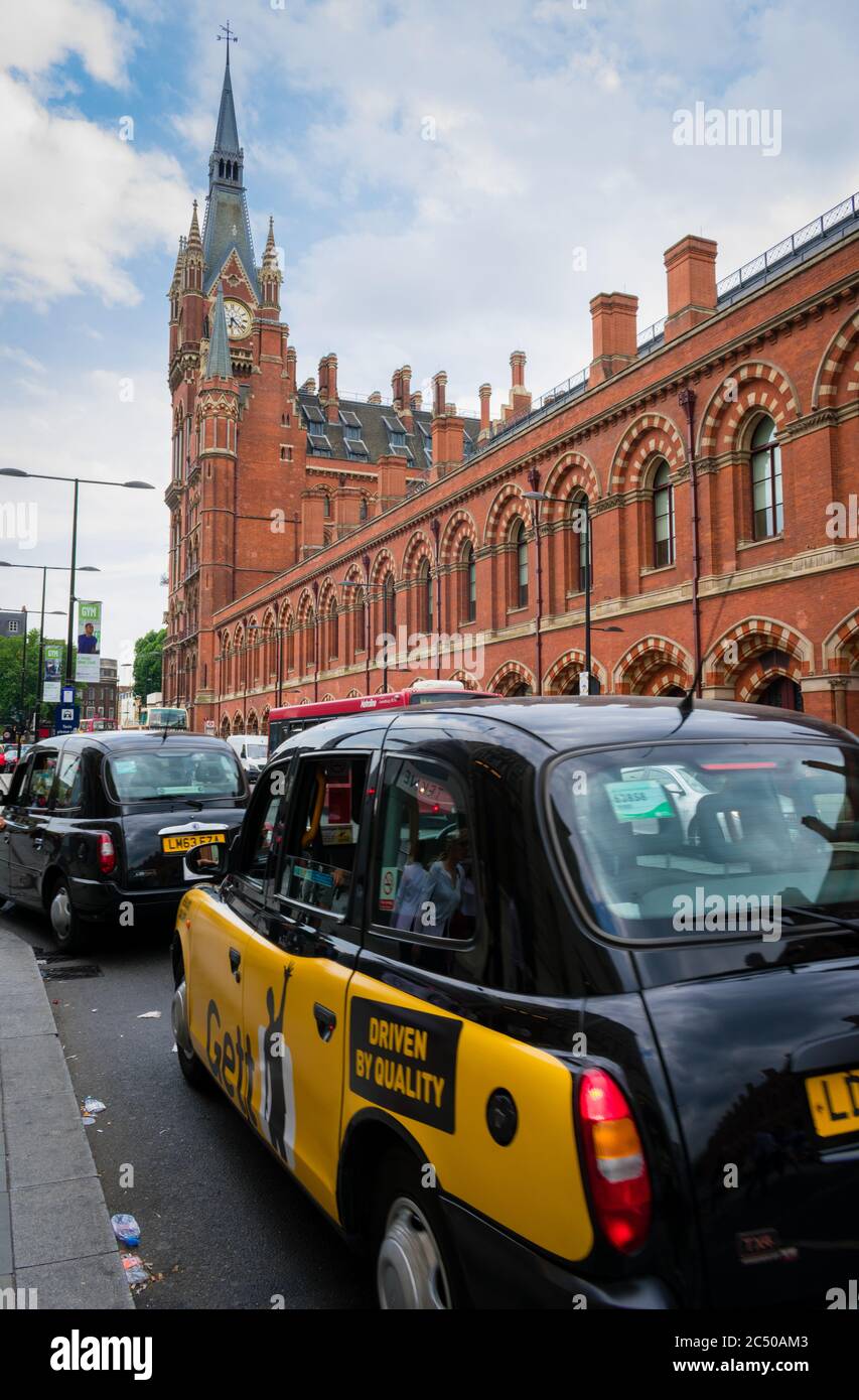 A exterior view of St. Pancras International railway station with London black cabs waiting to pick up passengers. Stock Photo
