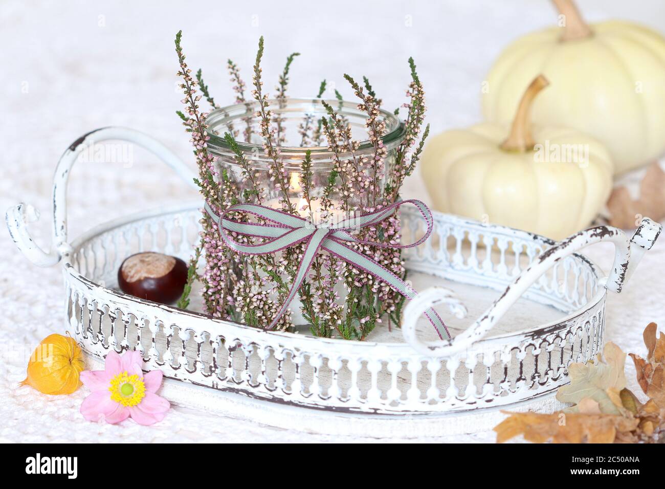 table lantern decorated with heather flowers as romantic autumn decoration Stock Photo