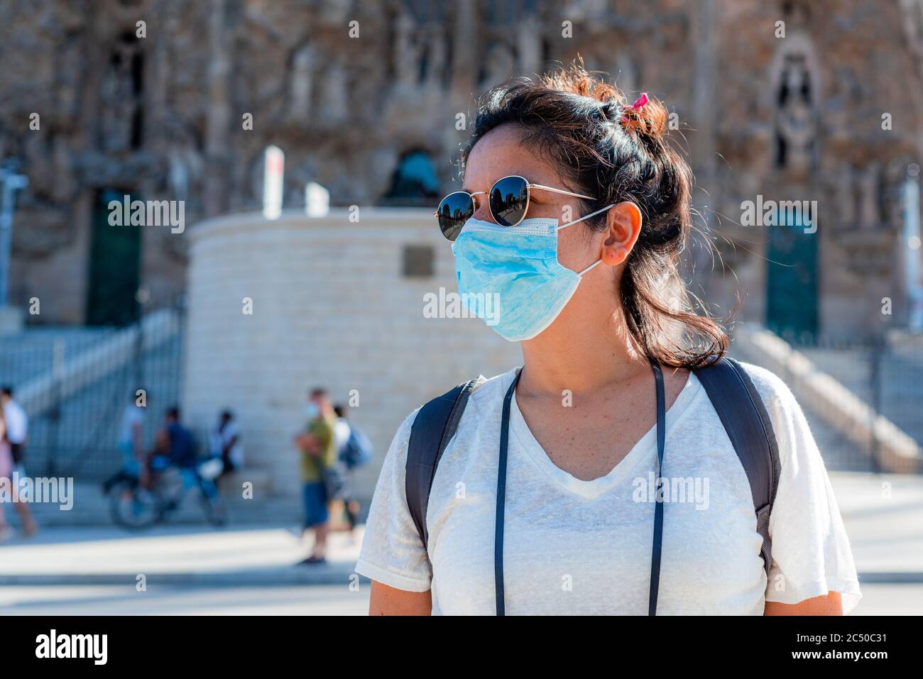 young tourist wearing face mask sightseing in european city. traveling and tourism industry during the corona virus pandemic and covid19 disease, affe Stock Photo