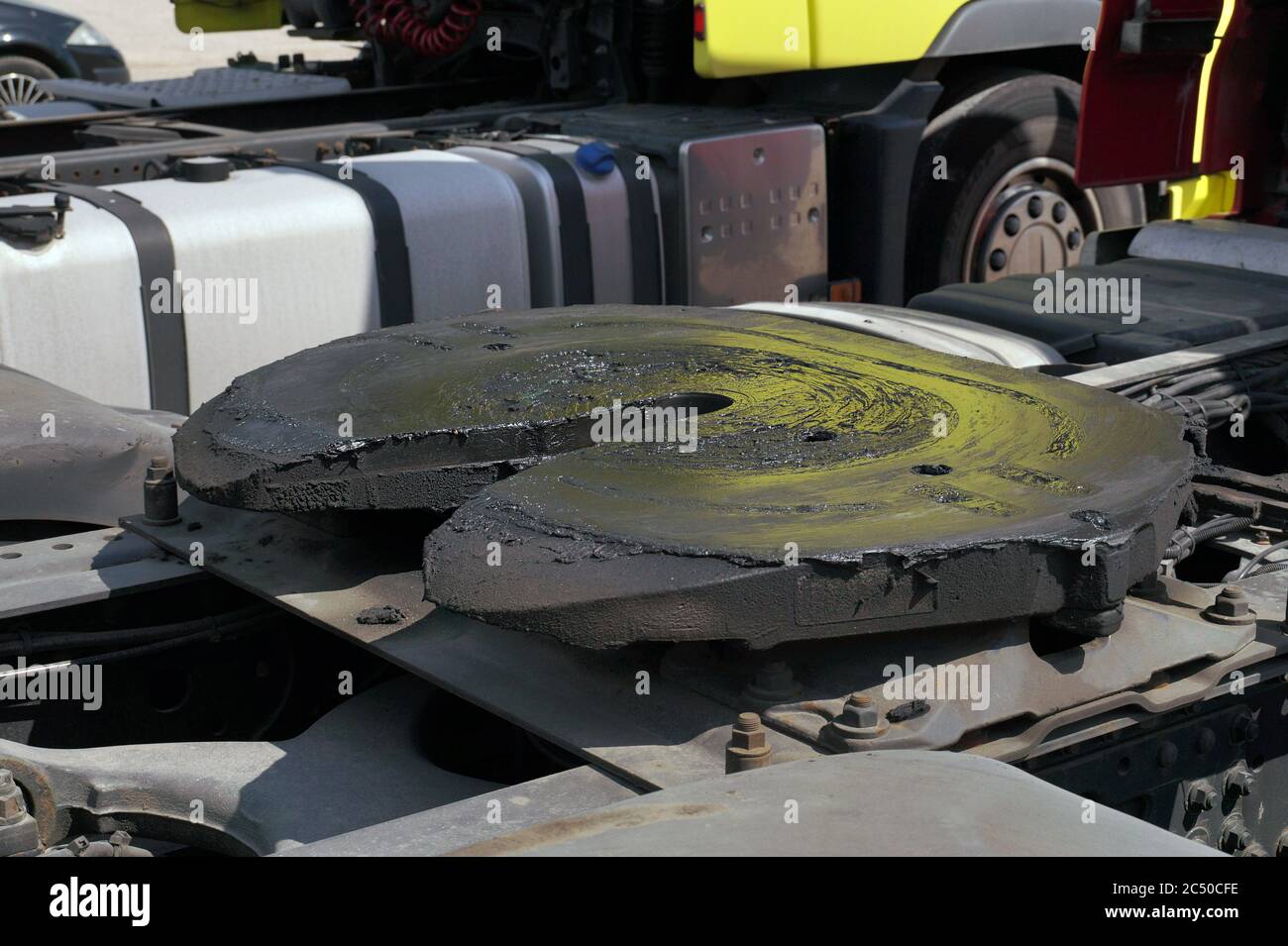 View of the back part of the 18 wheeled truck. Visible fifth wheel