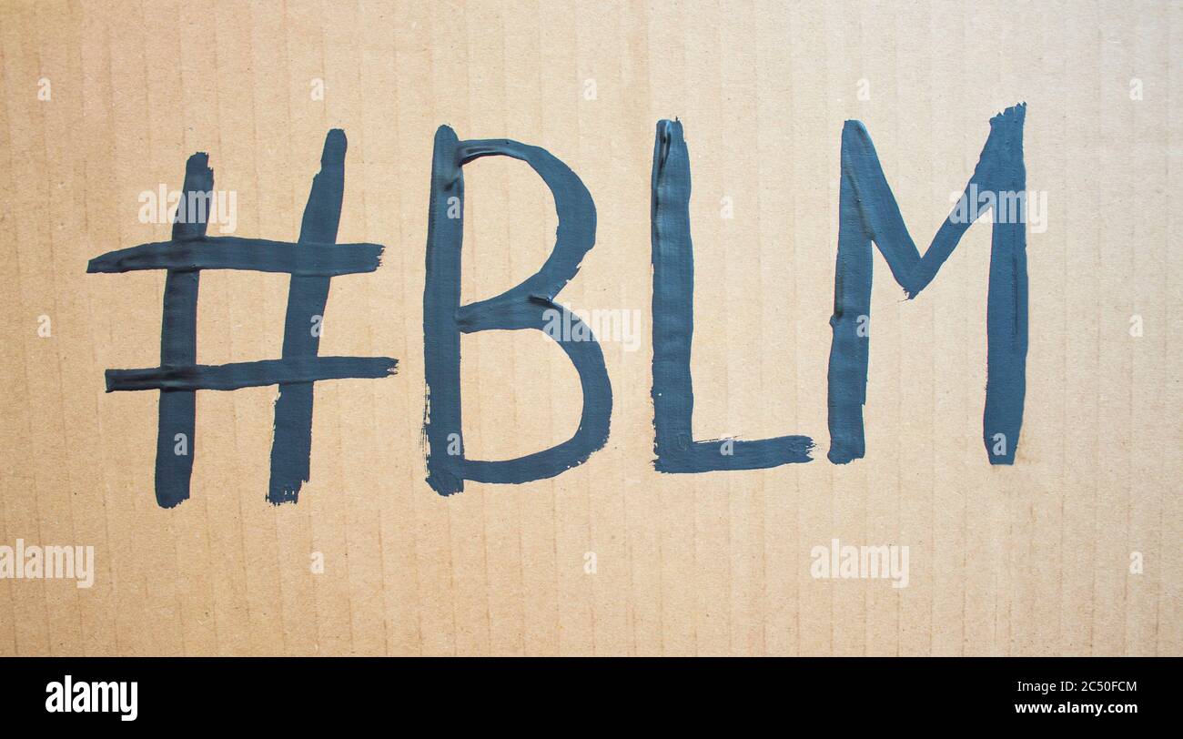 #BLM Text message for protest on cardboard. Stop racism. Police violence. Banner design concept. Stock Photo