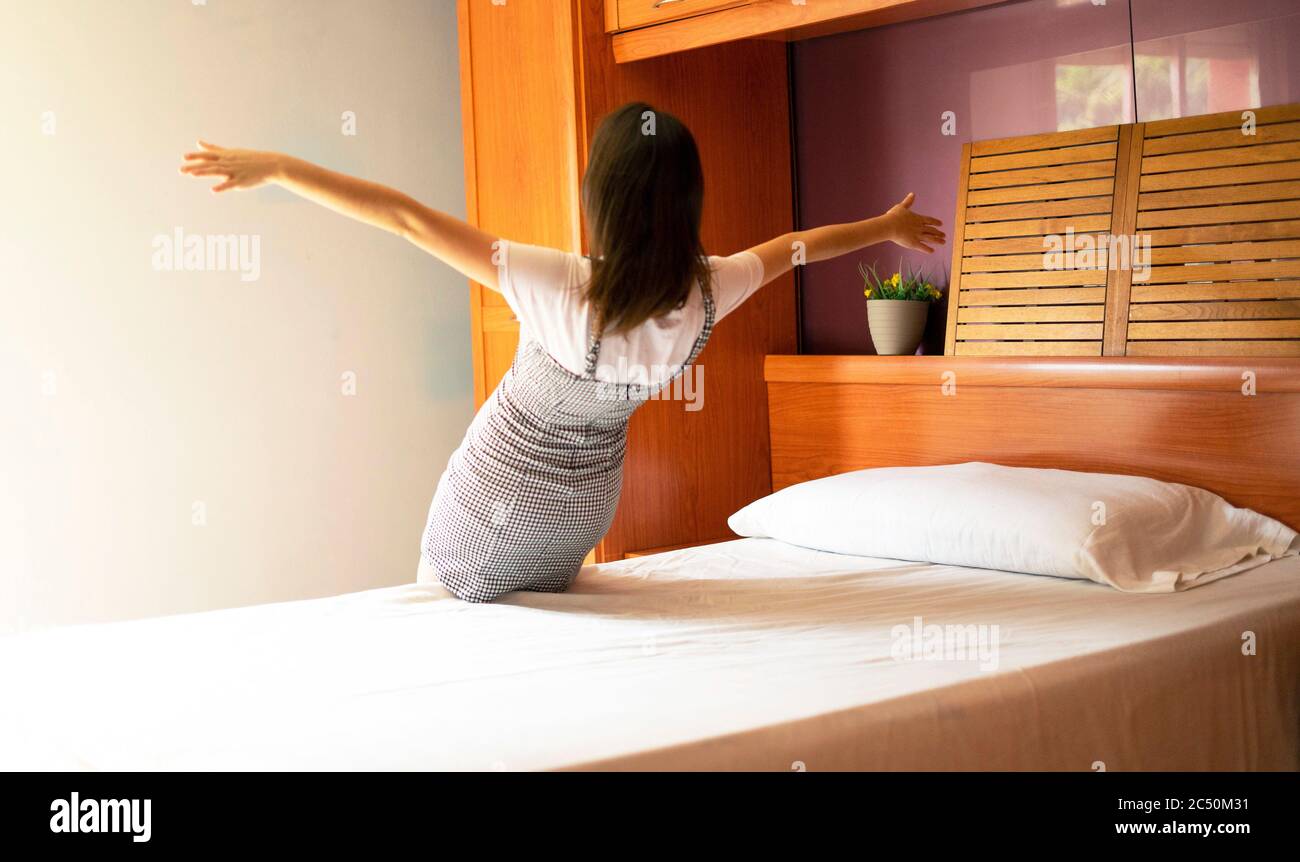 Unfocused woman throwing herself to bed. Concept of tiredness and rest