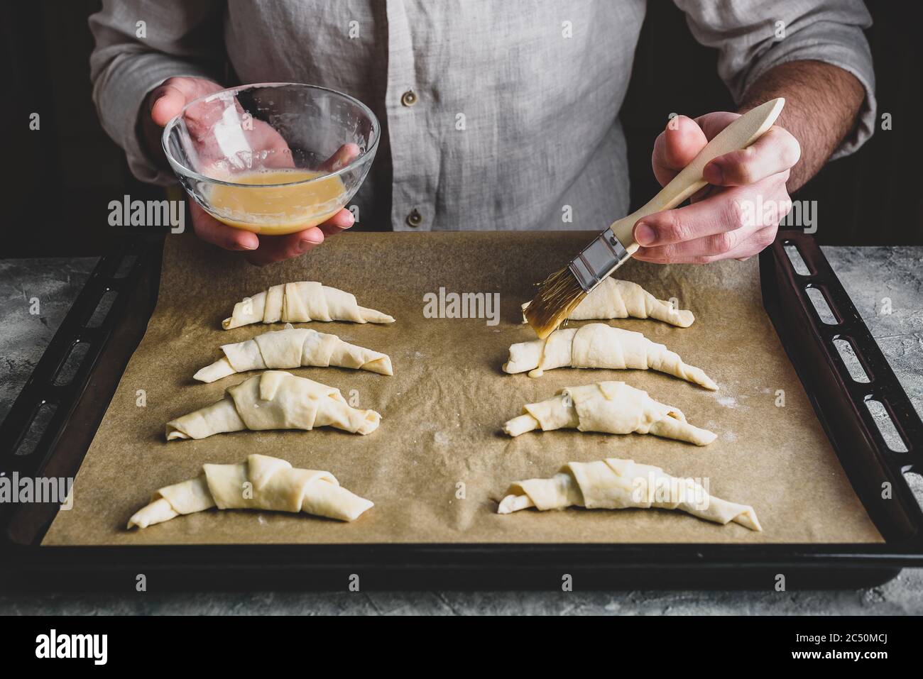 Baking sheet of raw croissants stuffed with chocolate spread Stock Photo