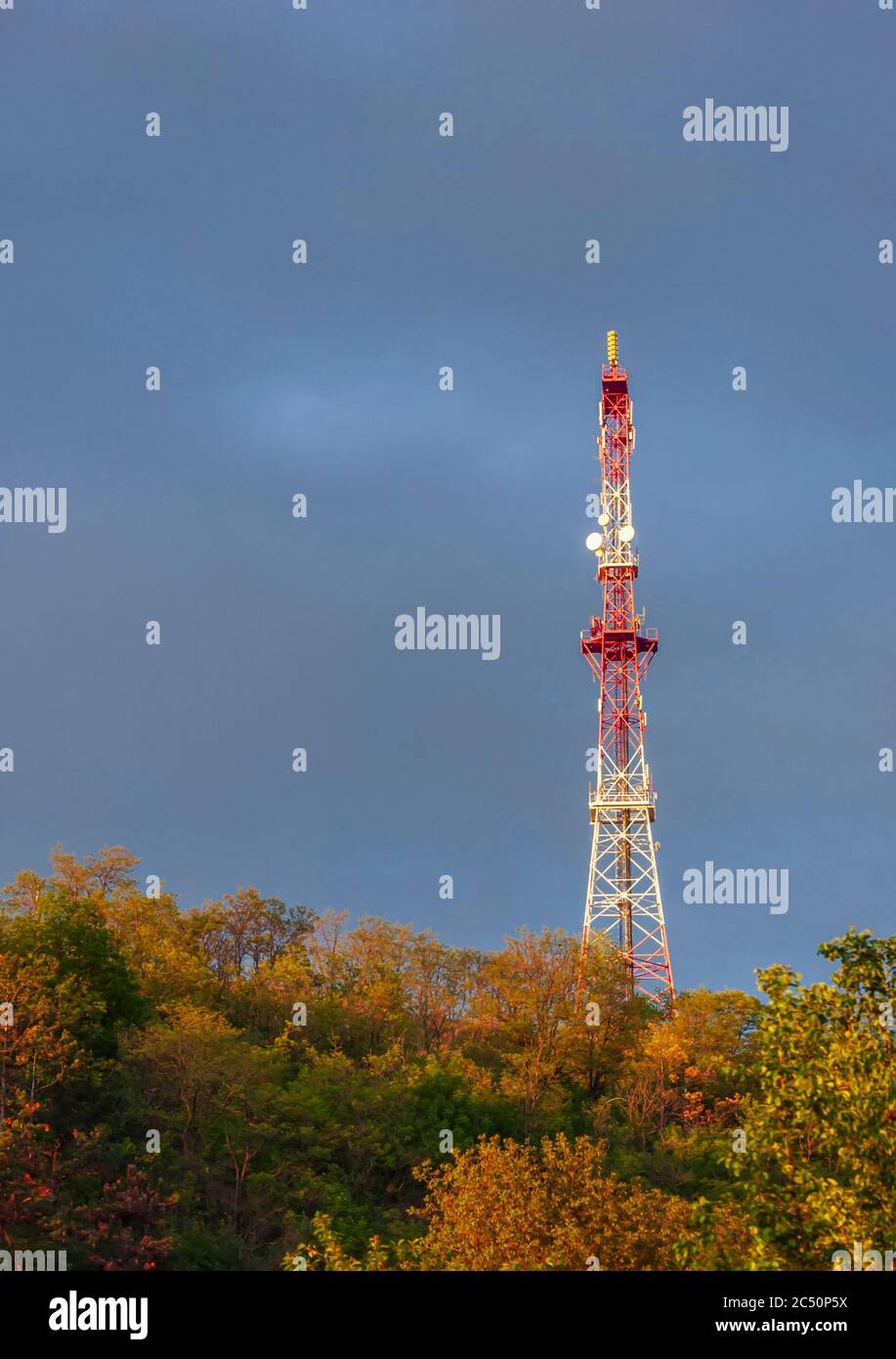 radio tower on a hill on evening sky background after storm rain Stock Photo