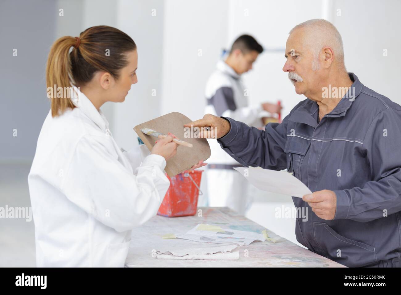 young house painter and decorator apprentice trainee Stock Photo