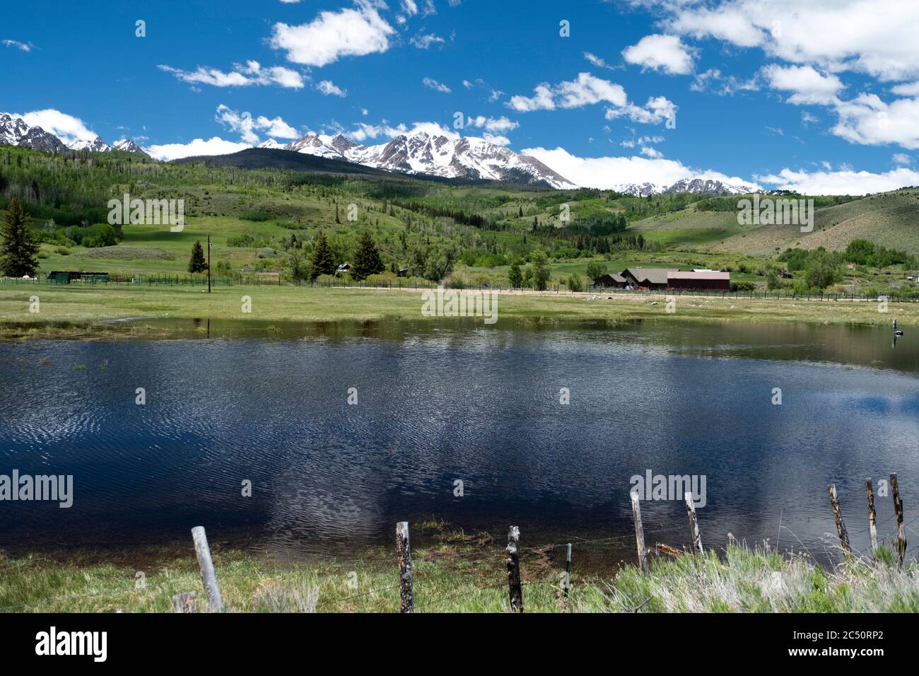 Scenic small lake in the Blue River Valley of Summit County with the Gore Range in the distance Stock Photo