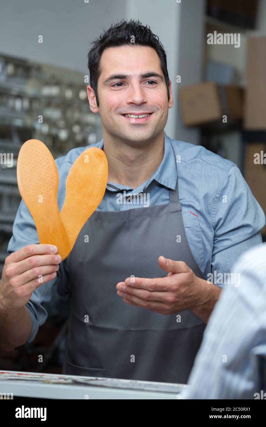 cobbler showing sole replacement for shoes Stock Photo