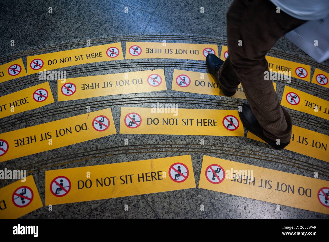 19.06.2020, Singapore, Republic of Singapore, Asia - Yellow prohibition signs are seen on steps at a MRT station that read Do Not Sit Here. Stock Photo