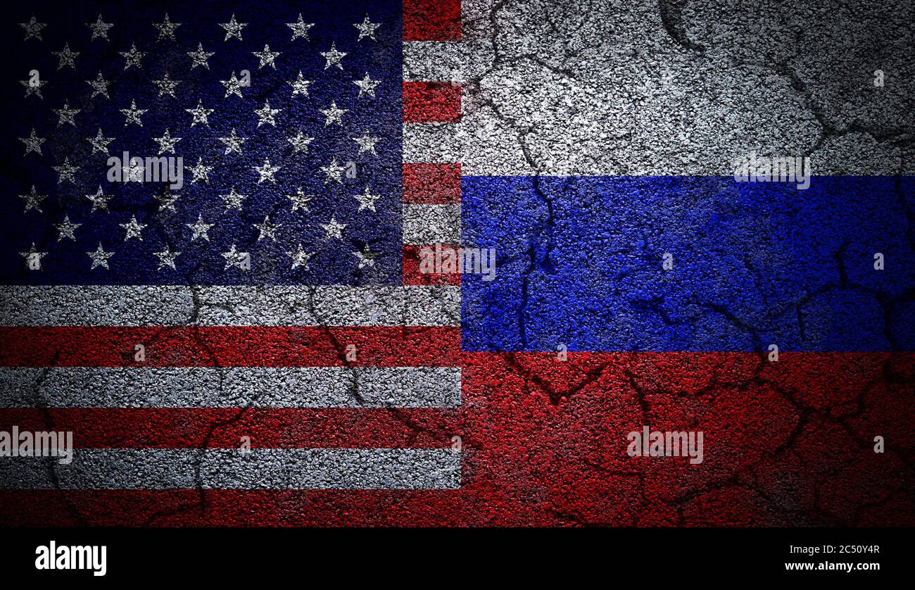 3D rendering of dual US and Russia flags painted on concrete wall in grunge effect with deep cracks to illustrate the broken or tense relations betwee Stock Photo