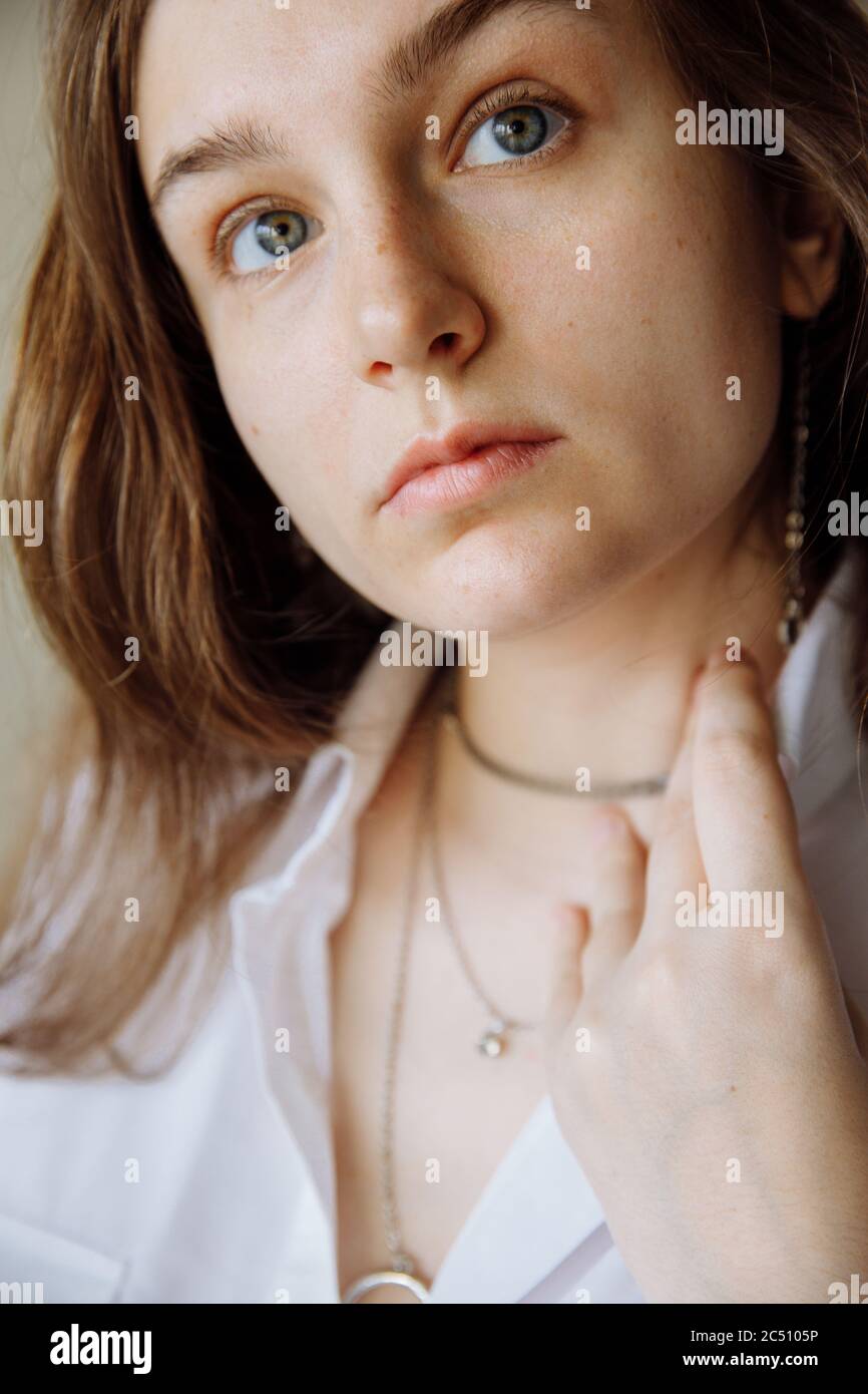 Face of a young brunette girl without makeup with natural features.  Stock Photo