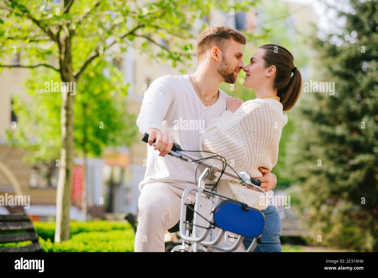 Man and woman hugging face to face in the park Stock Photo