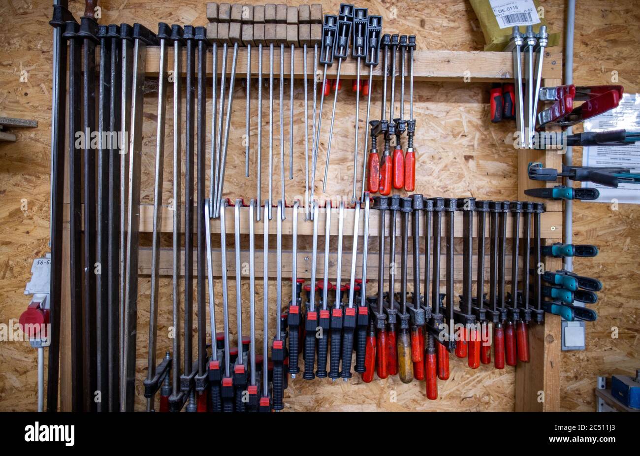 Rostock, Germany. 22nd June, 2020. Screw clamps are hanging in the workshop 'Historical keyboard instruments - Johann-Gottfried Schmidt'. The company, founded in 2003, is primarily active in the construction of musical instruments and employs three people. In the small company instruments such as chest and small organs, harpsichords, spinets, virginale and clavichords of the German and Italian building schools are made as individual unique pieces. Credit: Jens Büttner/dpa-Zentralbild/ZB/dpa/Alamy Live News Stock Photo