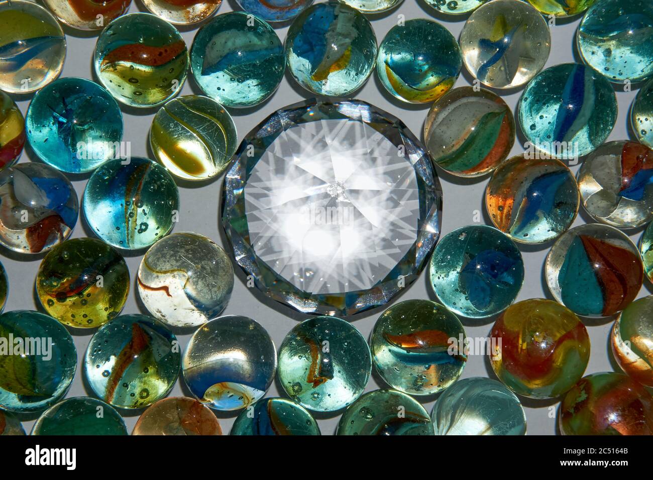 Yellow, green, blue and red glass marbles on a table Stock Photo Alamy