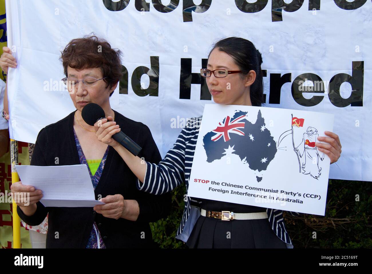 A lady who practices Falun Gong (Falun Dafa) speaks about her treatment in China at the hands of the Chinese Communist Party (CCP) at the protest outs Stock Photo