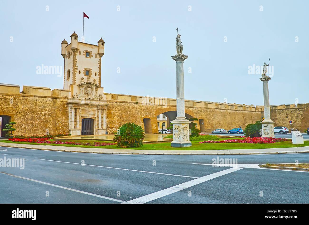 The medieval Earthen Gate (Earth Doors, Puertas de Tierra) with tower, fortress wall, white pillars with statues, located in Plaza de la Constitucion Stock Photo