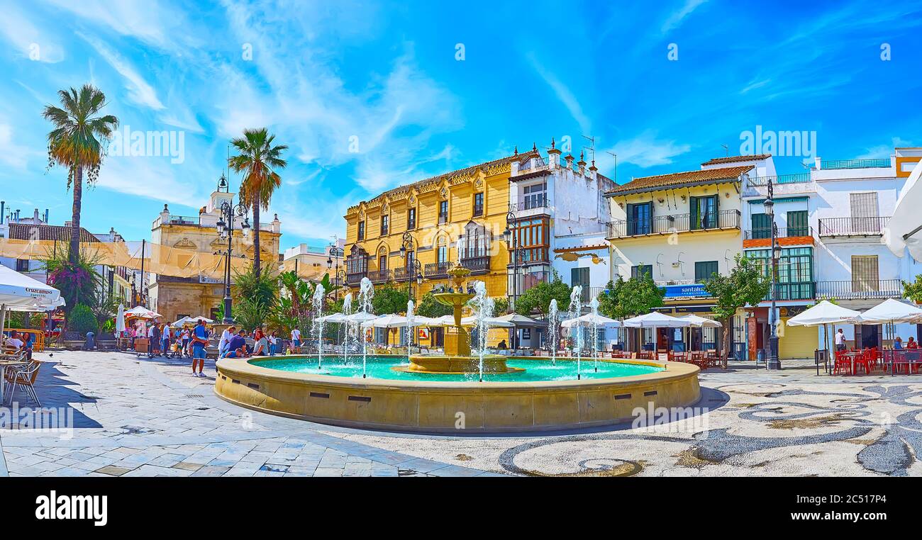 SANLUCAR, SPAIN - SEPTEMBER 22, 2019: Panorama of Plaza del Cabildo square with fountain, old town houses, outdoor cafes and wine bars, on September 2 Stock Photo