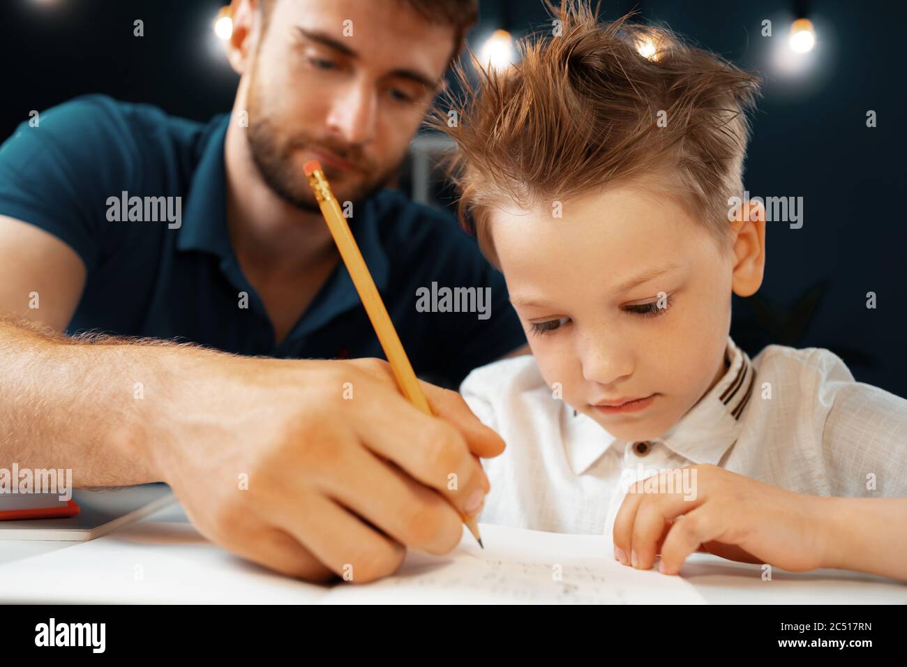 Father helping his little son with school homework Stock Photo - Alamy
