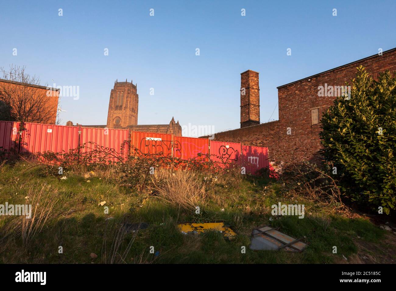 Liverpool Cathedral, glimpsed from derelict land on St James Street, Baltic Triangle, Liverpool, England, UK Stock Photo