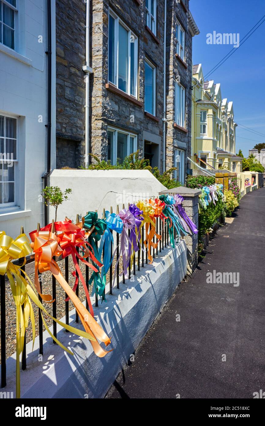 Virtue signalling with coloured ribbons on railings outside a middle class house in Castletown, Isle of Man Stock Photo