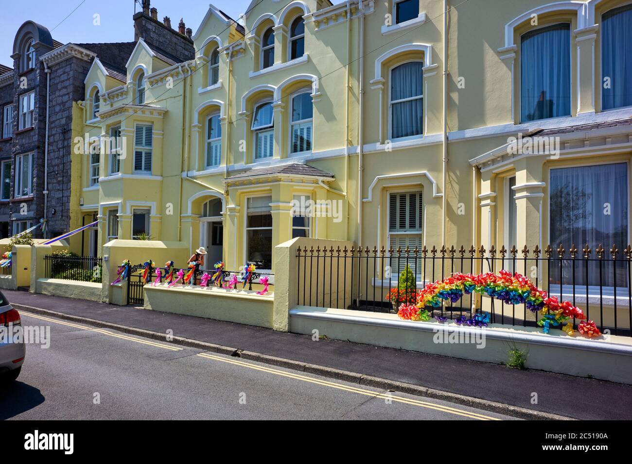 Virtue signalling of ribbons outside on railing of houses in The Crofts, Castletown, Isle of Man Stock Photo