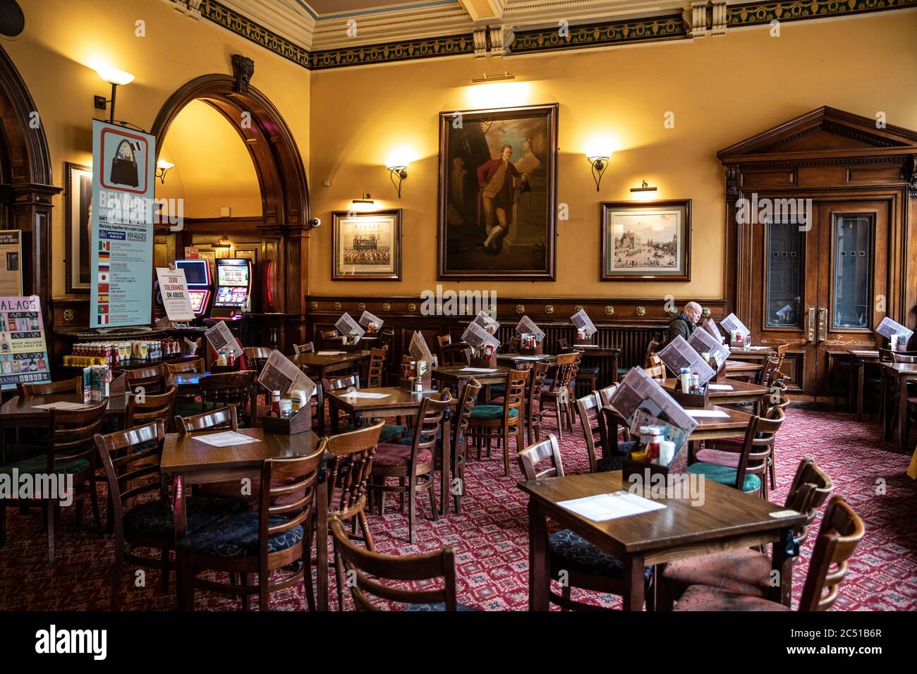 A lone drinker sits in an empty pub Lord Moon of The Mall days before the coronavirus Covid 19 pandemic lockdown is enforced across the United Kingdom Stock Photo