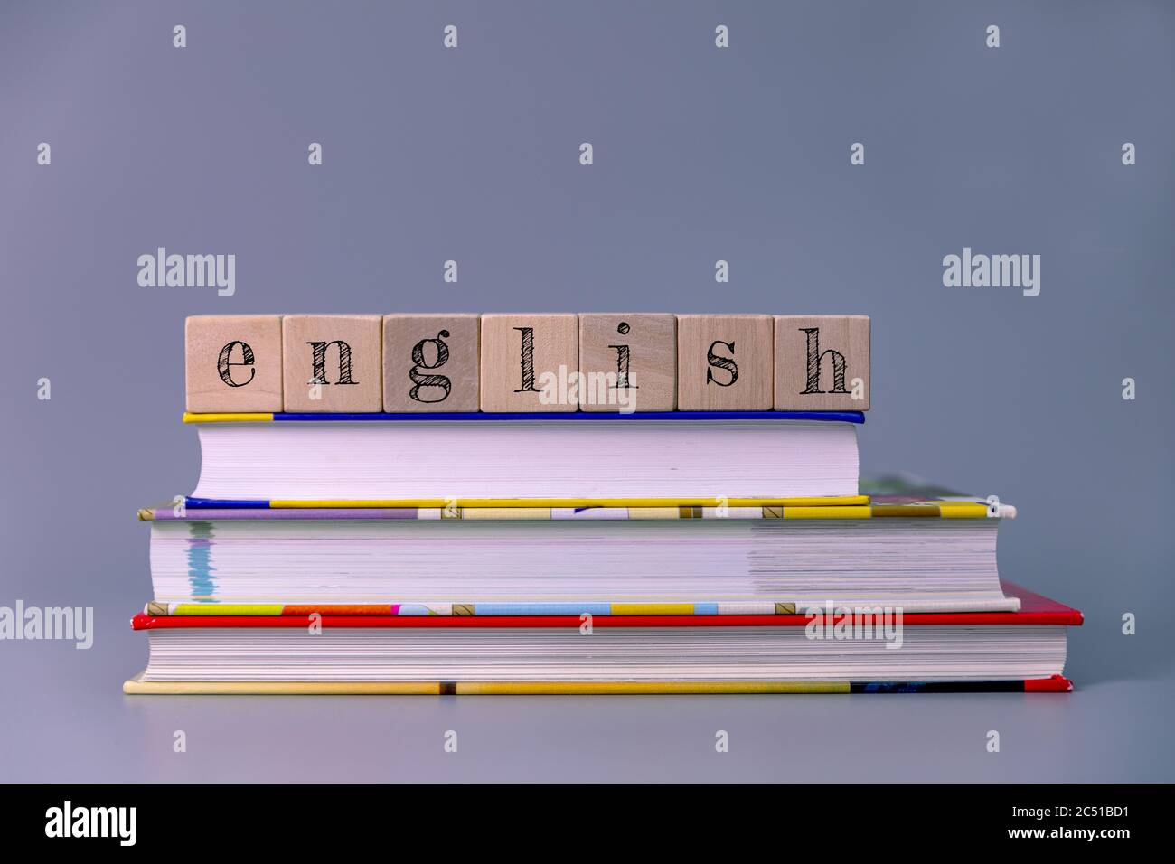 english language course and learning concept. stack of books with wooden blocks Stock Photo