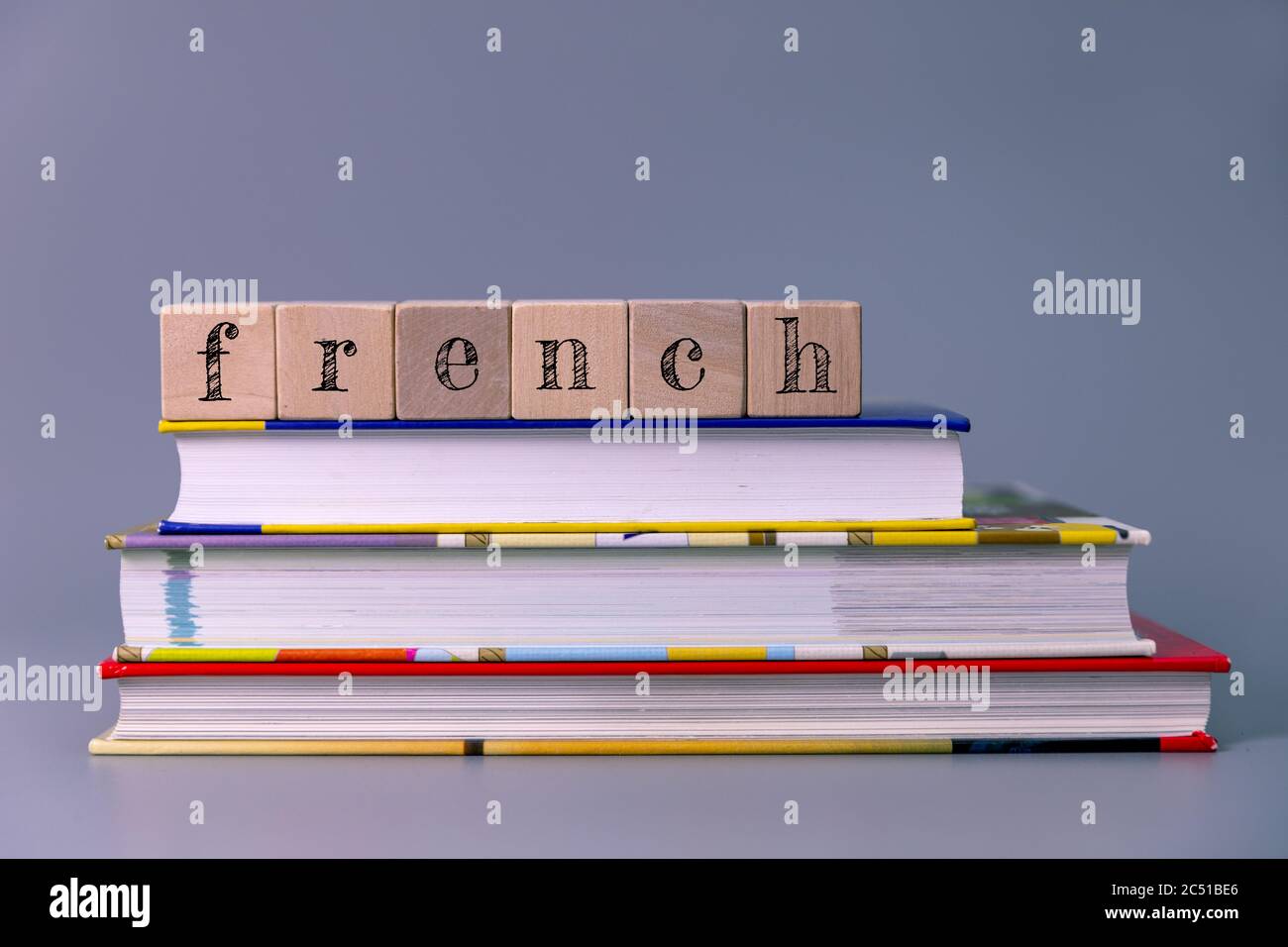 french language course and learning concept. stack of books with wooden blocks Stock Photo