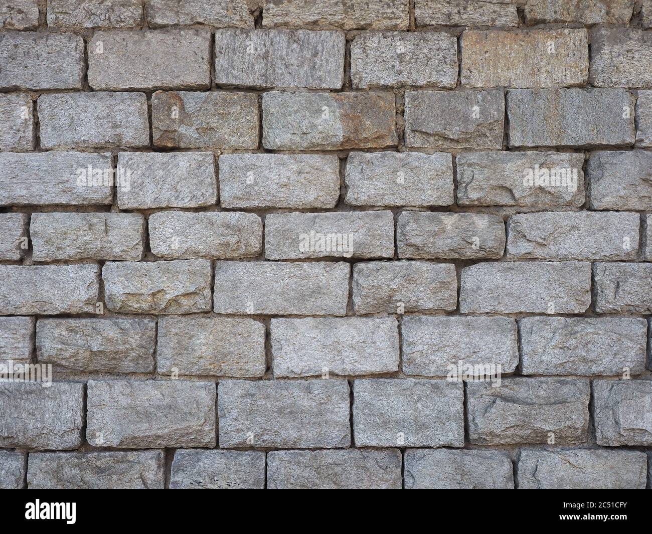 grey stone wall useful as a background Stock Photo - Alamy