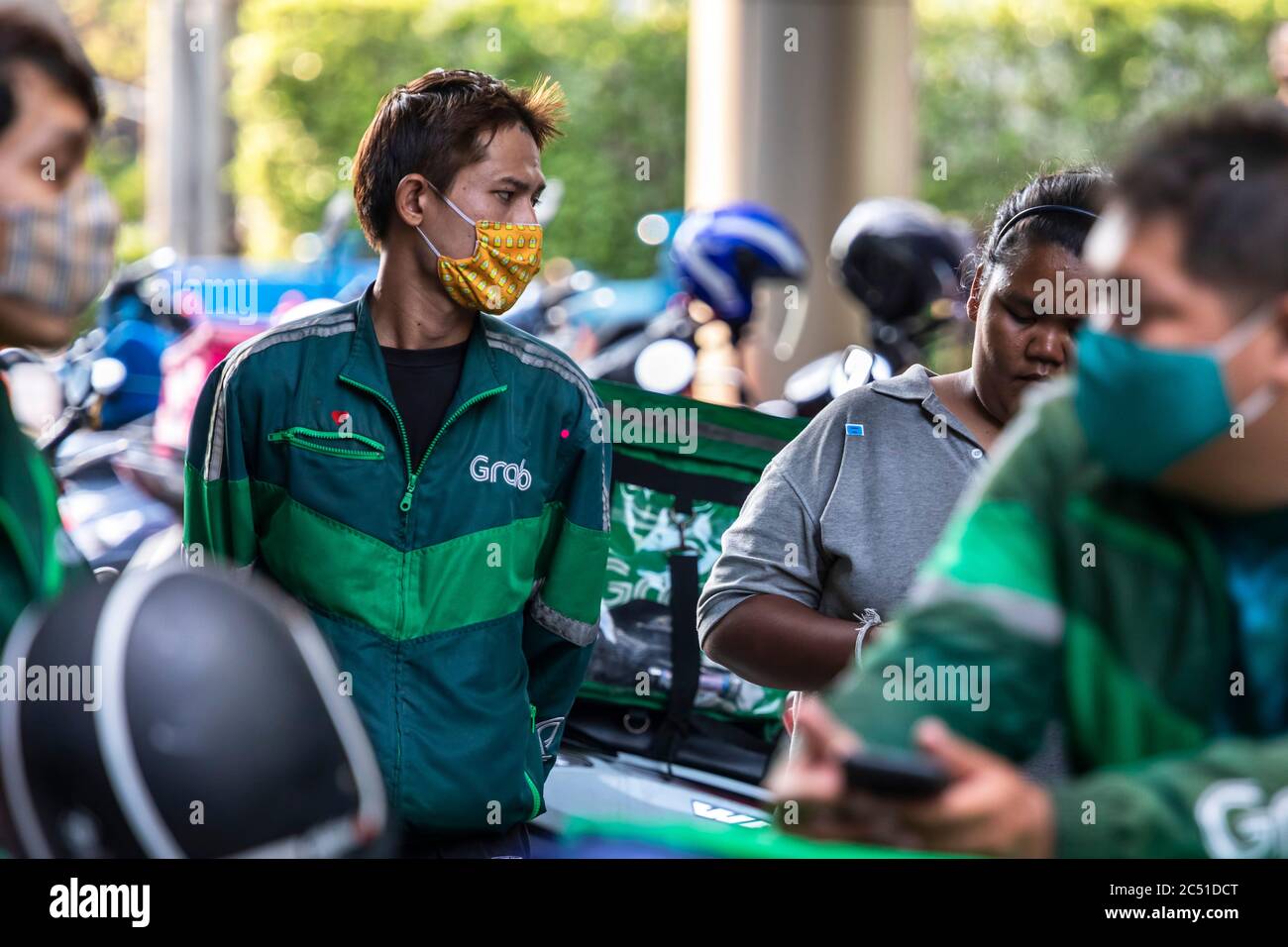 Grab motorcycle riders wearing facemasks during covid 19 pandemic, Bangkok, Thailand Stock Photo