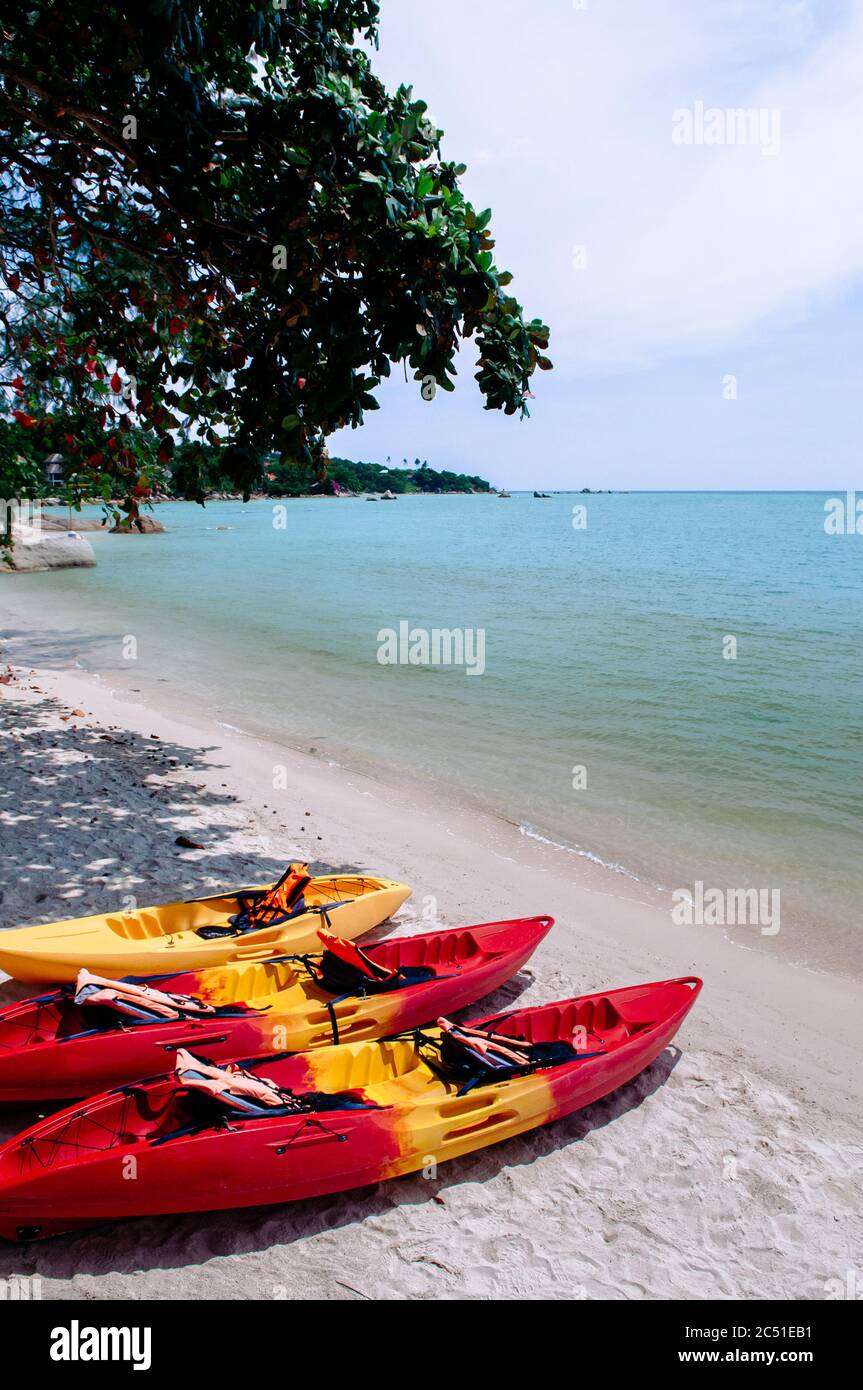 Colourful Kayak boats on tropical island beach in Thailand. Samui Island summer outdoor water sport activity Stock Photo