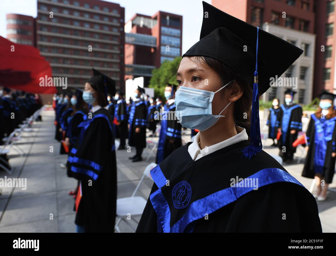 Beijing, China. 30th June, 2020. Graduates attend the commencement ceremony of Renmin University of China in Beijing, capital of China, June 30, 2020. Renmin University of China held a commencement ceremony for the graduates of 2020 on Tuesday. In order to reduce the risk of infection of COVID-19, only a minority of graduates attended the ceremony on site with the others attending online. Credit: Ren Chao/Xinhua/Alamy Live News Stock Photo
