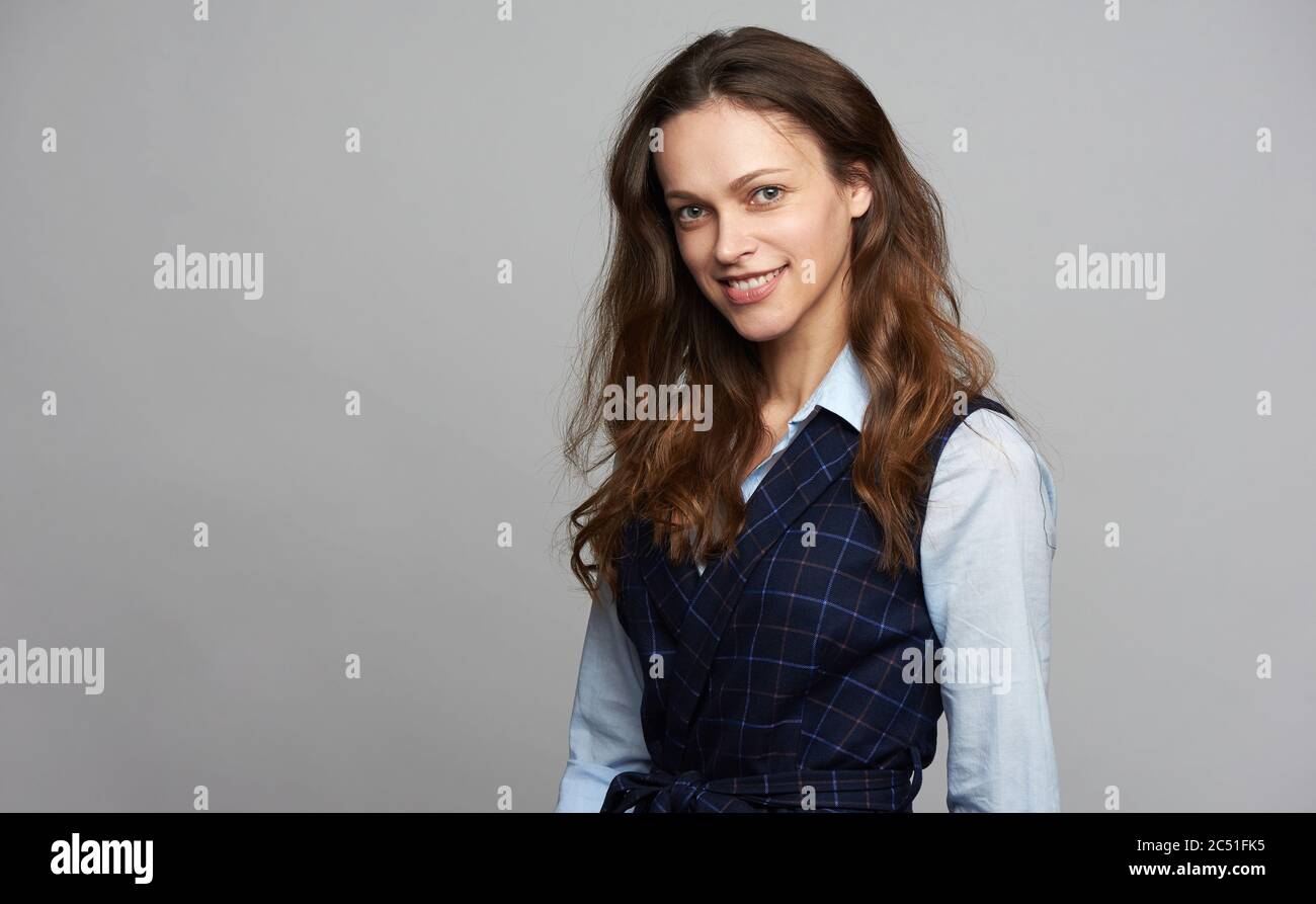 Pretty caucasian girl with long brown hair is looking at camera ...