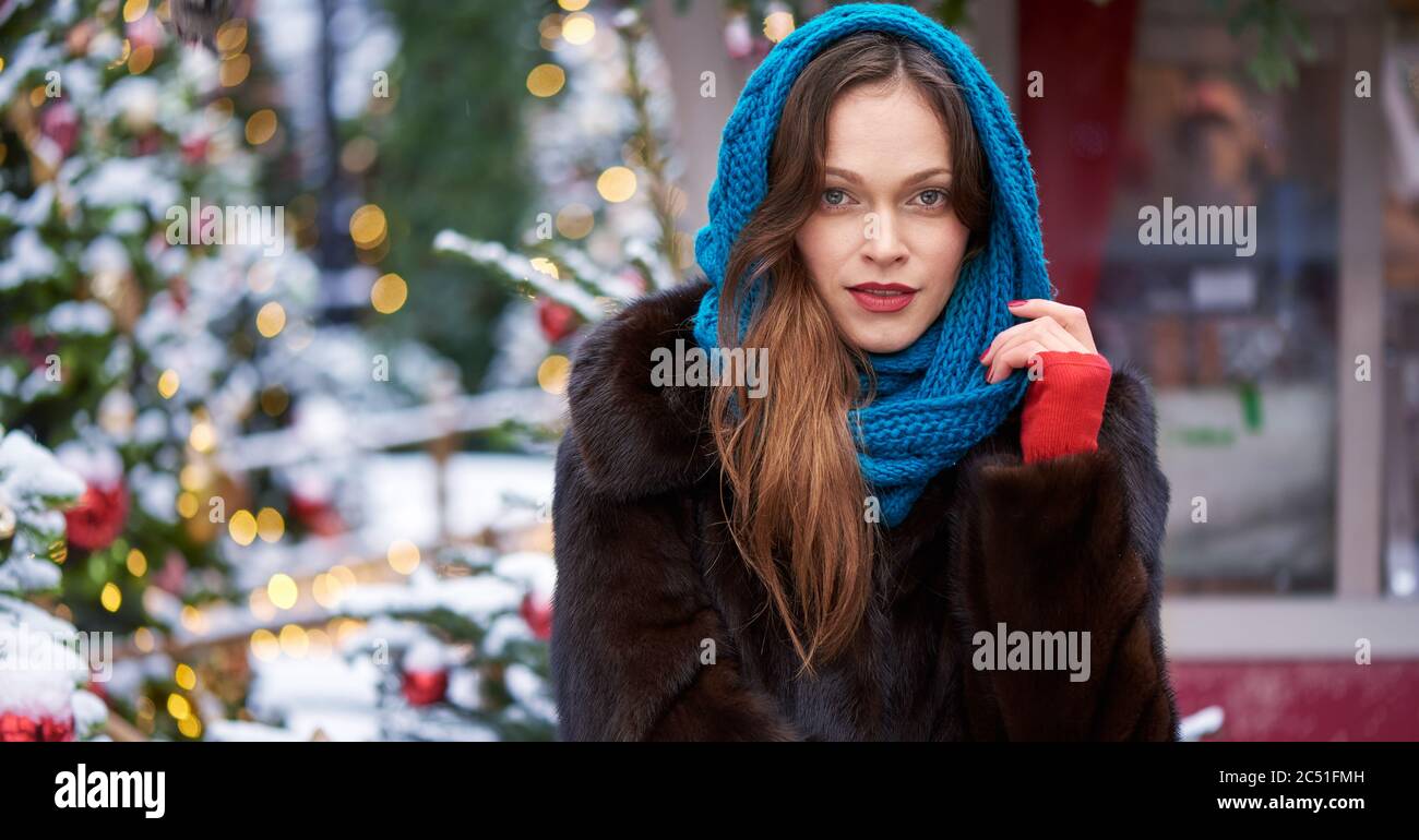 Pretty woman is wearing fur coat on a street in the new year day Stock ...