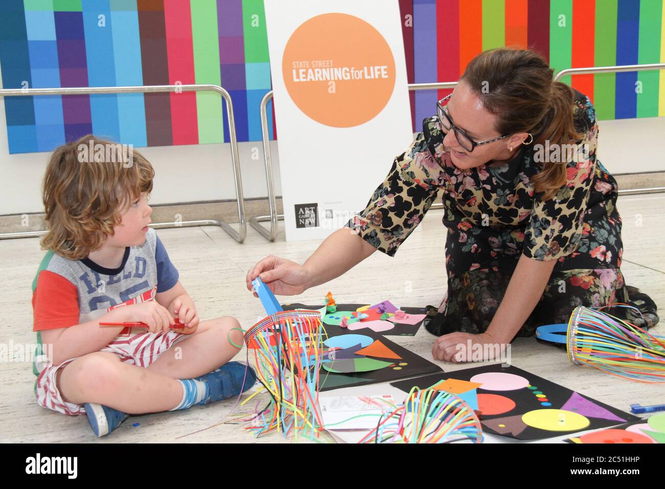 State Street Learning for Life program ambassador, artist Del Kathryn Barton plays with children at the launch event. Stock Photo