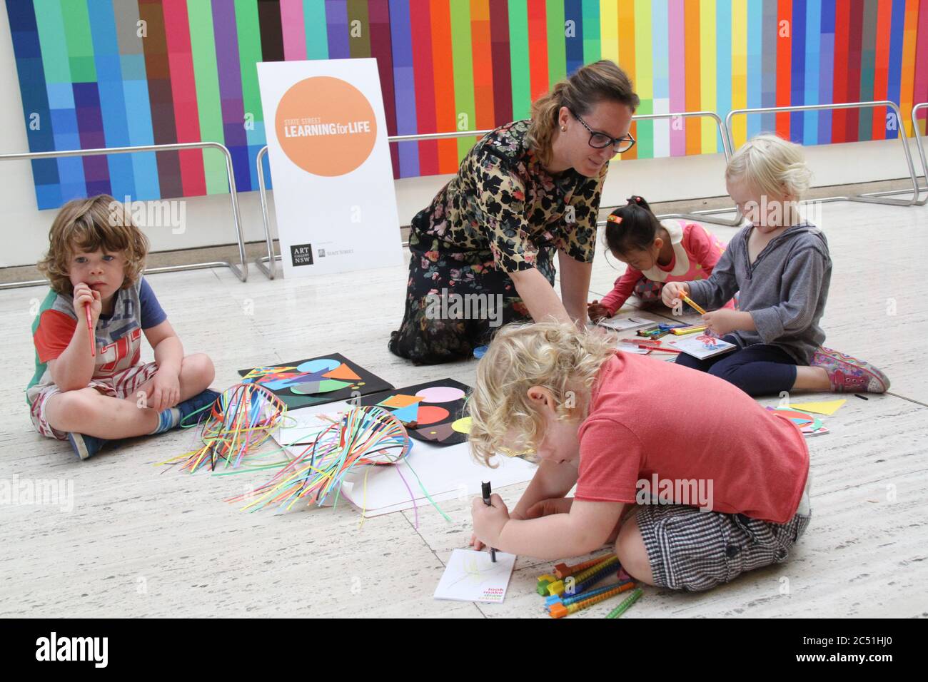 State Street Learning for Life program ambassador, artist Del Kathryn Barton plays with children at the launch event. Stock Photo