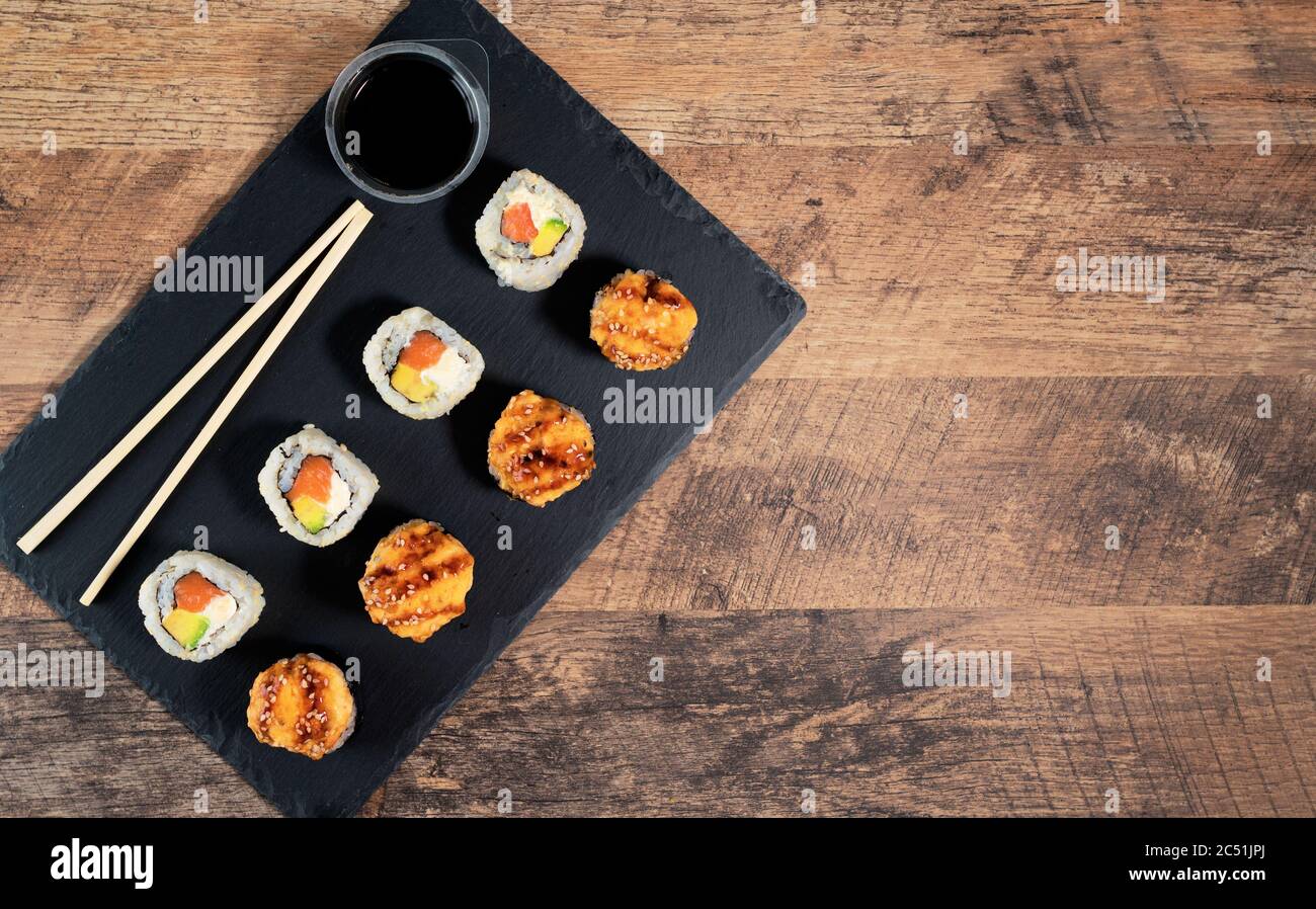 Sushi roll set on the black plate. Japanese food. Top view Stock Photo