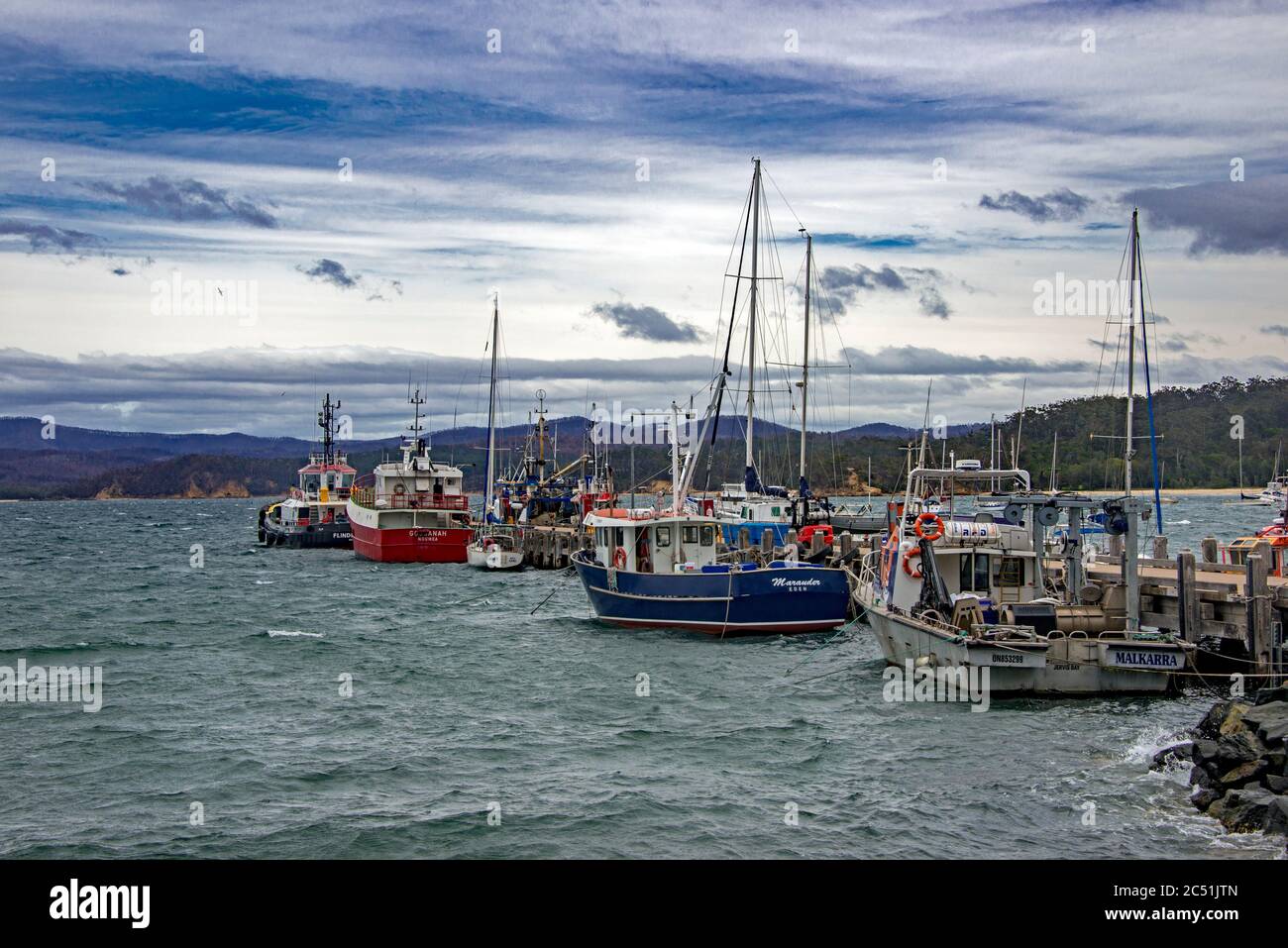 Berthed fishing boats in port Eden NSW Australia Stock Photo