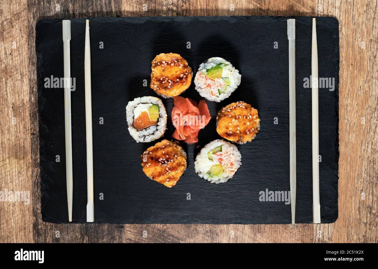 Sushi roll set on the black plate. Japanese food. Stock Photo