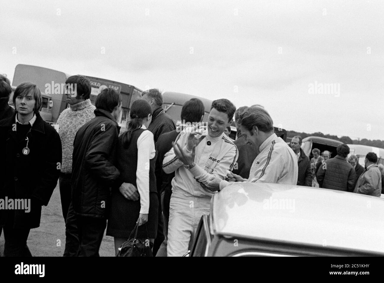 The late Barrie Williams in conversation with fellow mini racer John Rhodes at Brands Hatch in 1969. Guards International Trophy Meeting. Stock Photo