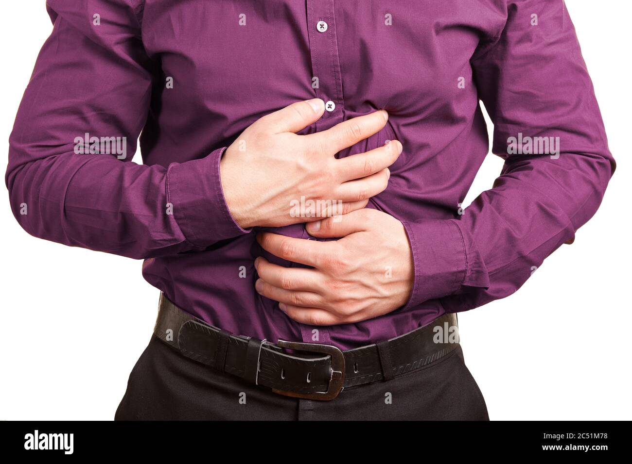 Young man with stomach ache holds hands to stomach Stock Photo