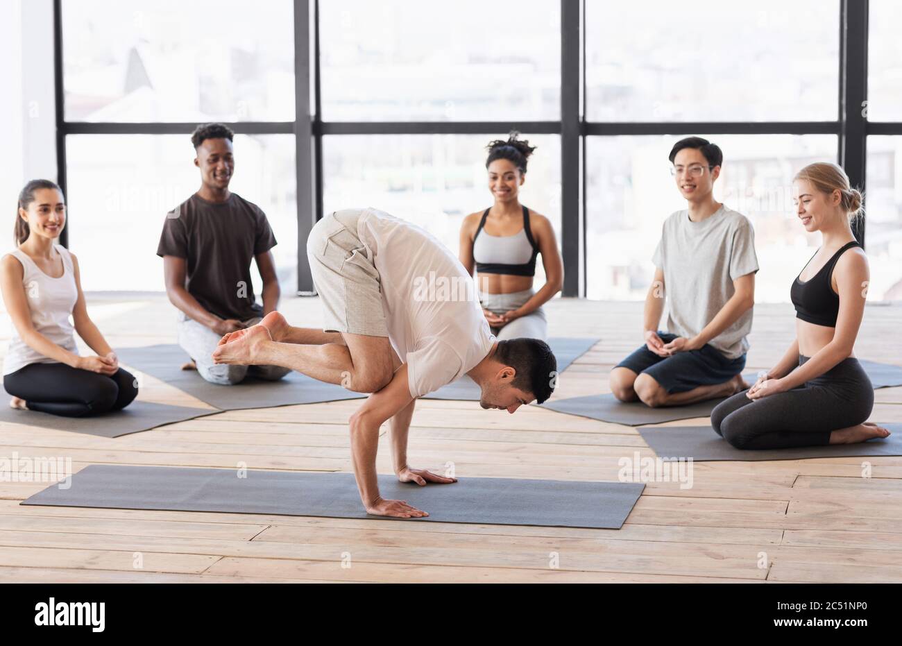 Professional yoga instructor showing asana exercises to beginners in class Stock Photo Alamy