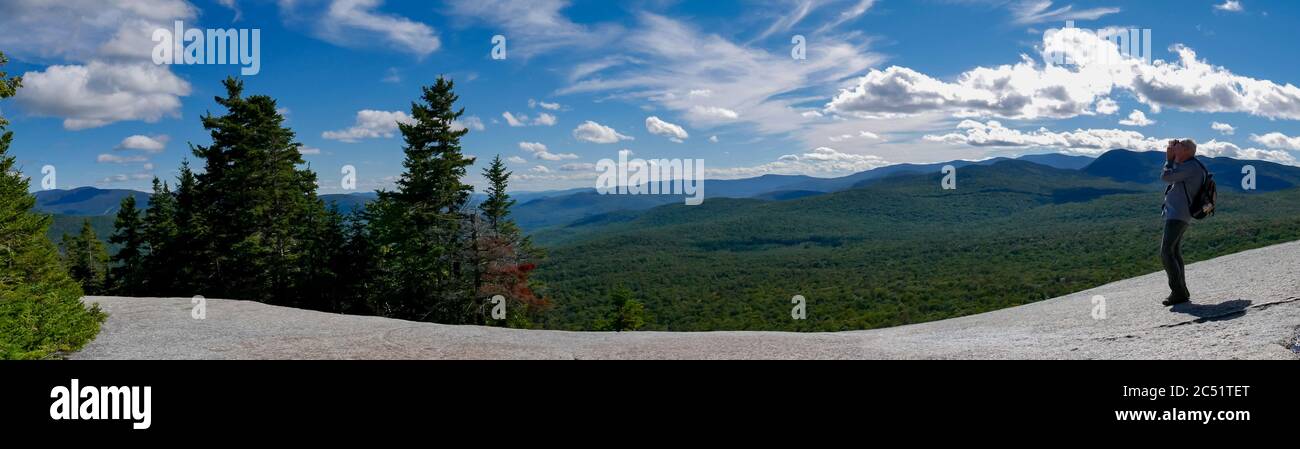 Senior man taking photo view on top of Mt Pemigewasset rocky plateau, White mountains, New Hampshire, USA Stock Photo