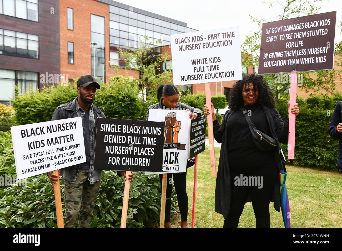 Dudley, West Midlands, UK. 30th June, 2020. As the Prime Minister Boris Johnson gave a speech in Dudley, a handful of protesters outside the college he was speaking in held up placards demanding full time nursery places for black children. Credit: Peter Lopeman/Alamy Live News Stock Photo