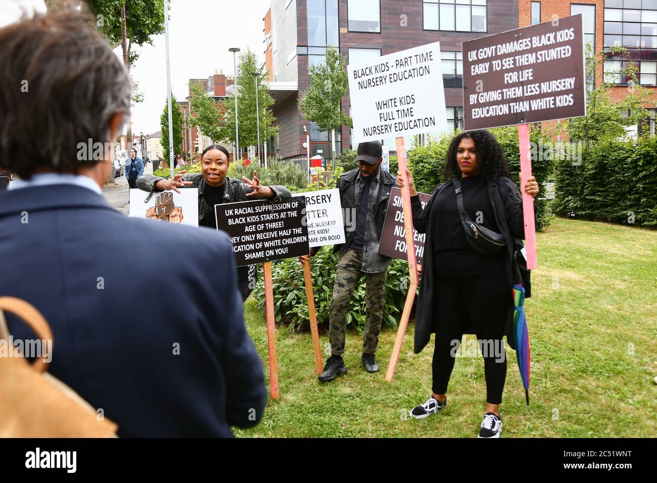 Dudley, West Midlands, UK. 30th June, 2020. As the Prime Minister Boris Johnson gave a speech in Dudley, a handful of protesters outside the college he was speaking in held up placards demanding full time nursery places for black children. Credit: Peter Lopeman/Alamy Live News Stock Photo