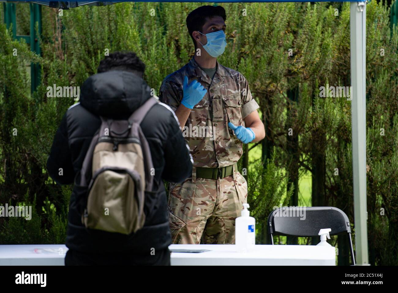 A member of the military instructs a person taking a test at a Covid-19 testing centre in Spinney Hill Park in Leicester, after the Health Secretary Matt Hancock imposed a local lockdown following a spike in coronavirus cases in the city. Stock Photo