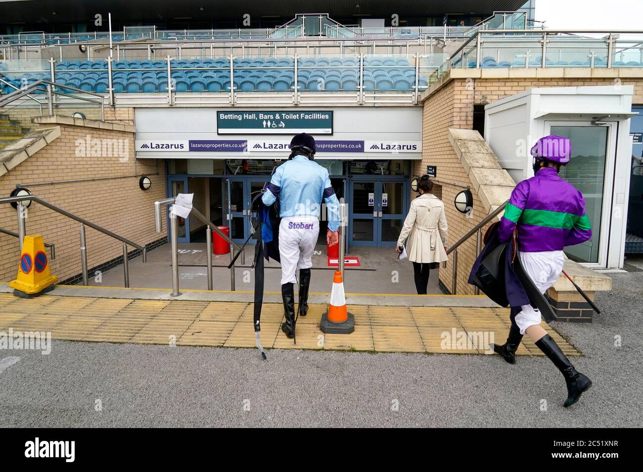 A general view as jockeys return to their makeshift weighing room in the exhibition hall at Doncaster Racecourse. Stock Photo