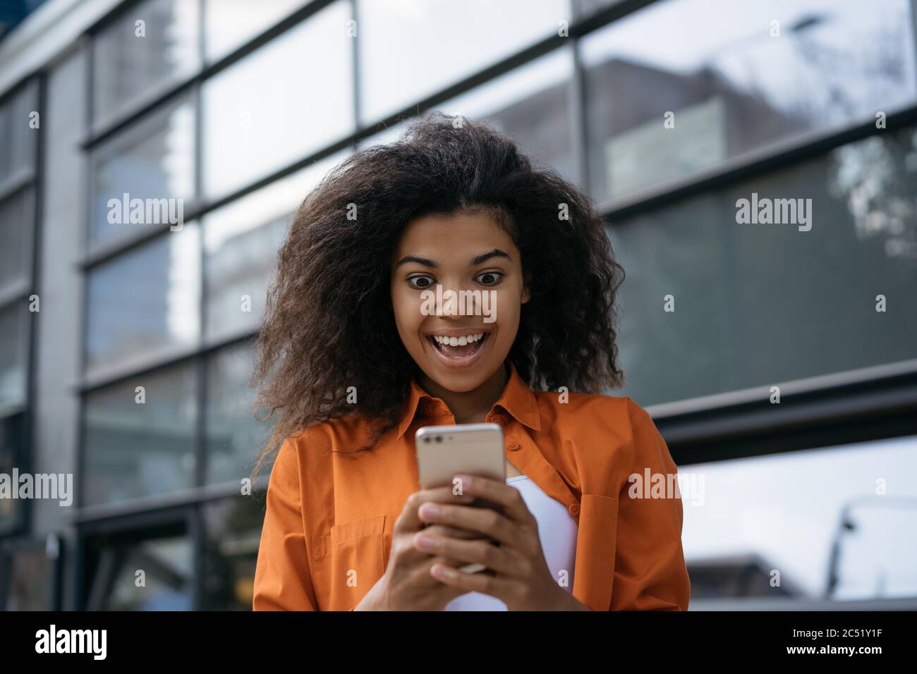 Overjoyed woman using cellphone with mobile application for online shopping with low price, cash back Stock Photo