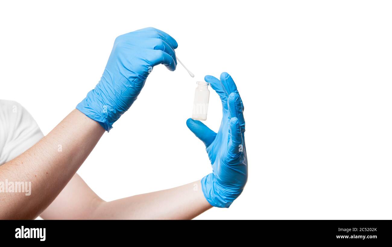nurse hand in a blue sterile gloves to give cotton swab to bottle for ...